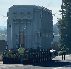 A heavy-haul truck and trailer carried the 450,000 lb. transformer to its final destination. A heavy-haul truck and trailer carried the 450,000 lb. transformer to its final destination.