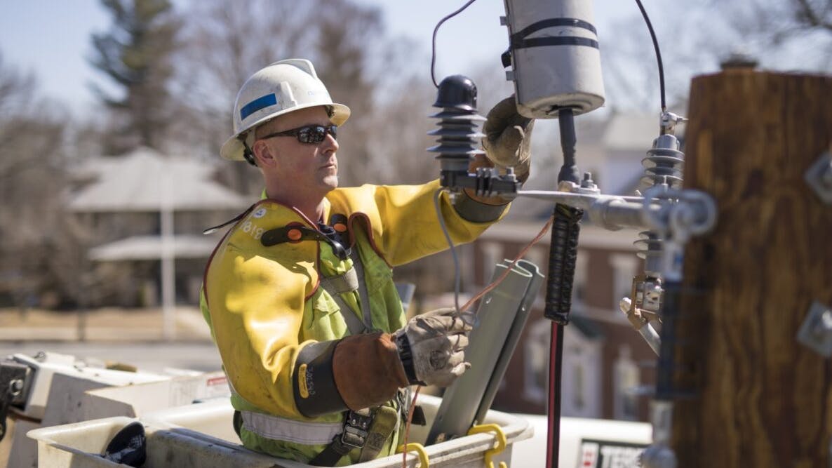 A worker installs poletop gear to a distribution line. National Grid&rsquo;s Future Grid Plan, backed by DOE funding, will invest in network infrastructure, new transformers, power lines and substations, including line monitoring systems and communications systems.