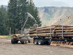 Logs from fuel reduction efforts being loaded on trucks for transport to community firewood bank programs. Photo by D. Southard. Logs from fuel reduction efforts being loaded on trucks for transport to community firewood bank programs. Photo by D. Southard.