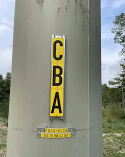 Essential safety signage, readable from both ground and air, ensures technicians and drones identify towers correctly and understand associated dangers. Essential safety signage, readable from both ground and air, ensures technicians and drones identify towers correctly and understand associated dangers.