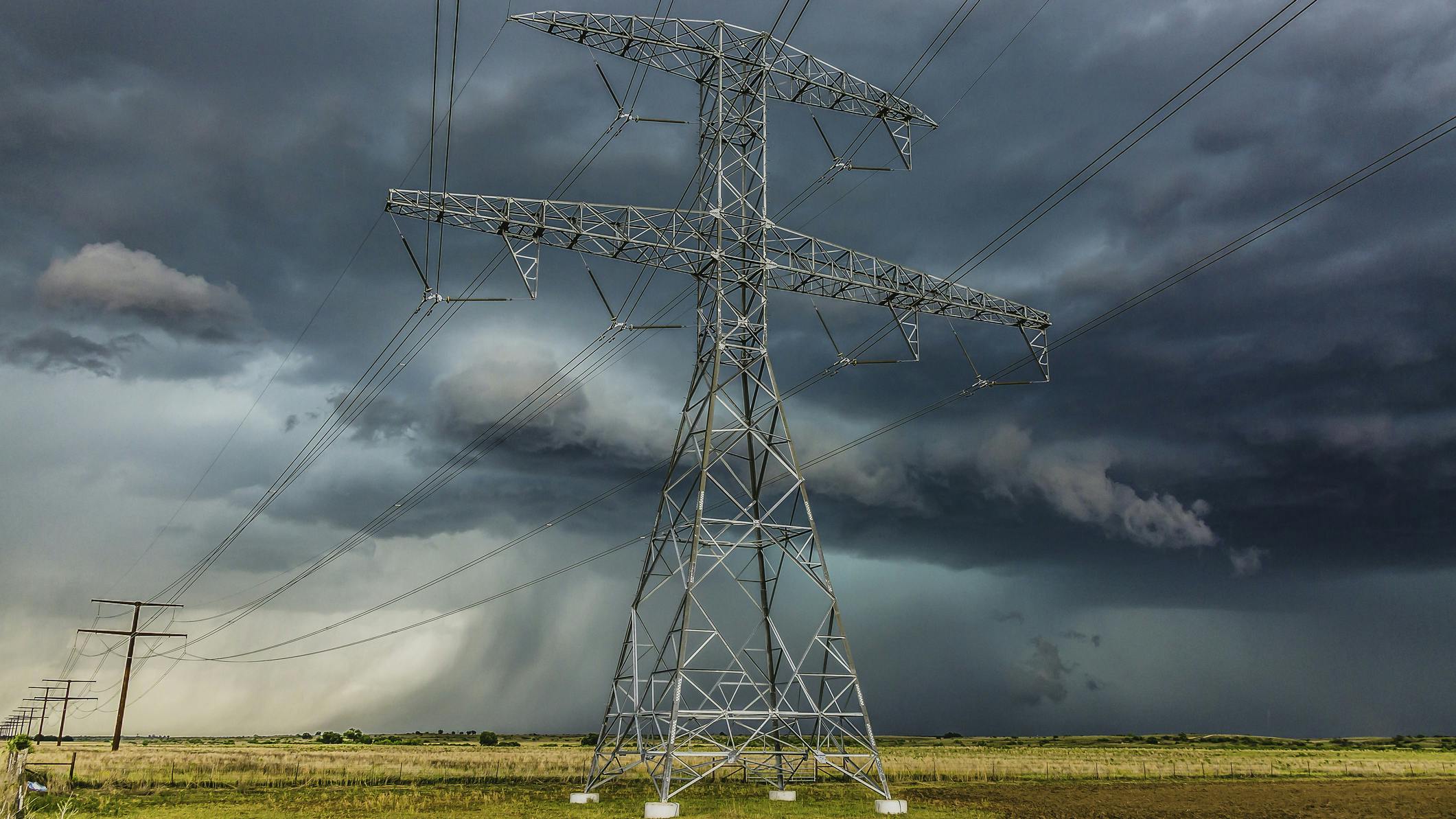 power lines in front of storm clouds