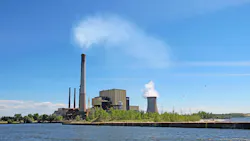 Power plant on Lake Michigan in Indiana. Coal- and gas-fired power plant of the Michigan City Generating Station and public beach on the shore of Lake Michigan near Michigan City, Indiana Power plant on Lake Michigan in Indiana. Coal- and gas-fired power plant of the Michigan City Generating Station and public beach on the shore of Lake Michigan near Michigan City, Indiana