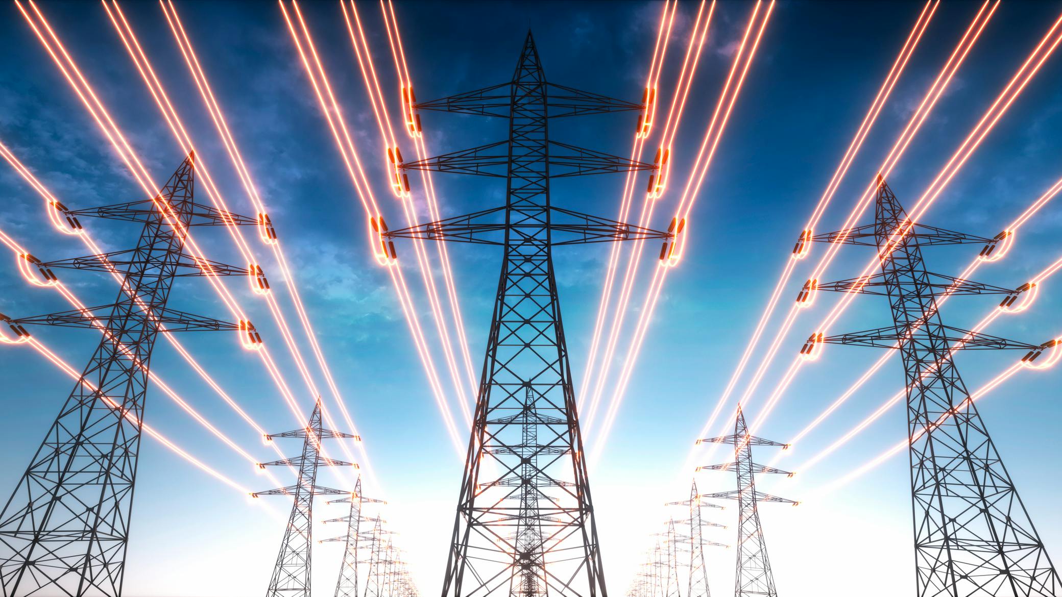 Electricity transmission towers with red glowing wires