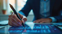 A man in a suite working on a computer tablet. A man in a suite working on a computer tablet.