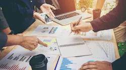 Colleagues meeting for strategy planning with data graphs and other documents. Colleagues meeting for strategy planning with data graphs and other documents.