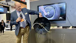 Craig Smith, VP of marketing and communications for P.S.I., demonstrates the new aerodynamic wheel cover with integrated Easy Air Access. Craig Smith, VP of marketing and communications for P.S.I., demonstrates the new aerodynamic wheel cover with integrated Easy Air Access.