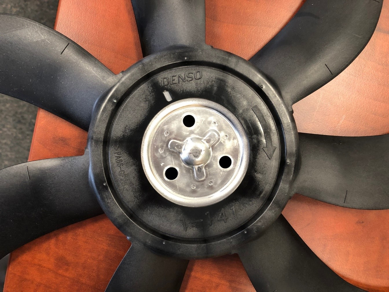 Software locates the plastic cooling fan hub to set the search region for the OCR tool, which moves the region part-to-part, making the search more repeatable.