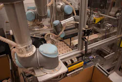 Figure 2: Universal Robots UR3 and UR5 arms pick and place the godets onto trays and cases respectively. Figure 2: Universal Robots UR3 and UR5 arms pick and place the godets onto trays and cases respectively.