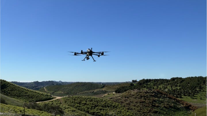 A drone equipped with the Q.Fly Water system in flight.