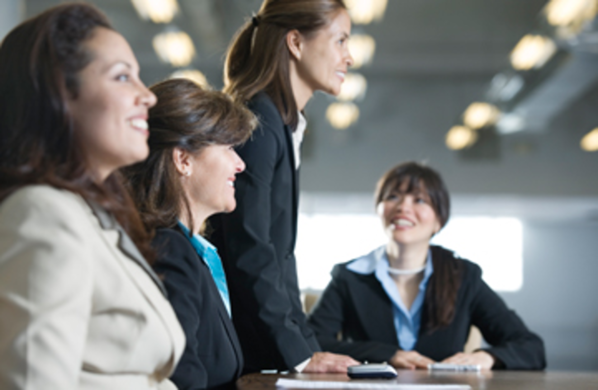 Four businesswomen in a meeting in the board room