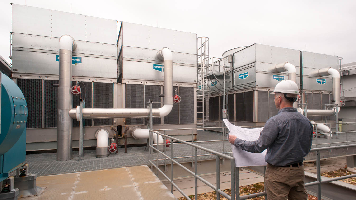 An engineer looks over a new cooling tower installation.