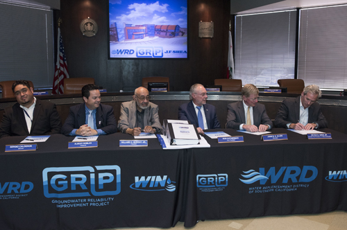 WRD Board of Directors and J.F. Shea Construction sign historic water project construction agreement.