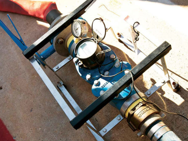 The portable OMNI Verification (V2) portable test meter is placed in-line to check the accuracy and performance of large, commercial meters without interrupting service.