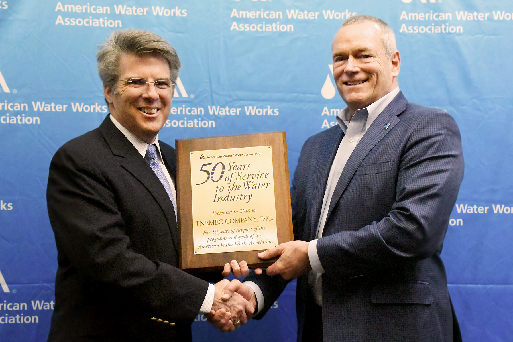 AWWA CEO David LaFrance (left) congratulates Randy Moore, Director of Sales-Agency Development and Industry Affairs and Vice President of the AWWA Board of Directors.