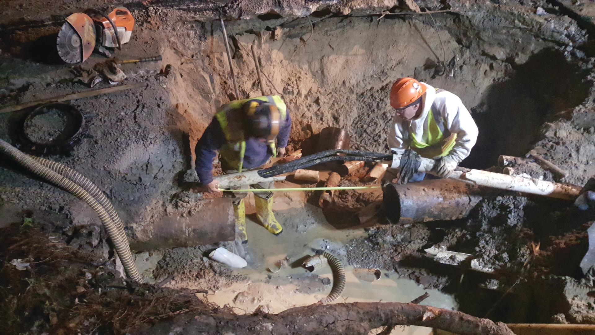 Utility workers addressing a water line break.