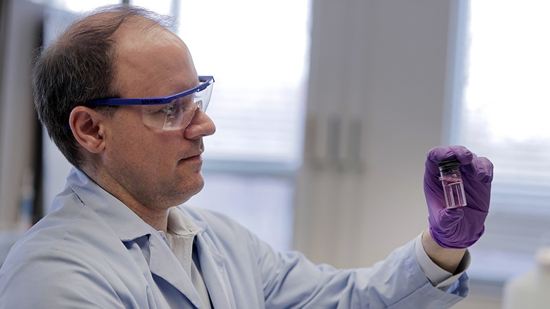 Purdue engineering professor Andrew Whelton holds up a water sample from a building faucet. The pink color indicates the presence of chlorine, a disinfectant. Whelton&rsquo;s team is investigating how water quality might change in buildings during a time of limited occupancy due to the COVID-19 pandemic.