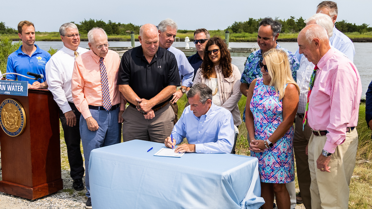 Governor John Carney signing the Clean Water for Delaware Act at a public event on July 22.