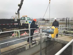 Workers%20lower%20new%20mixer%20down%20into%20well%20copy Workers%20lower%20new%20mixer%20down%20into%20well%20copy