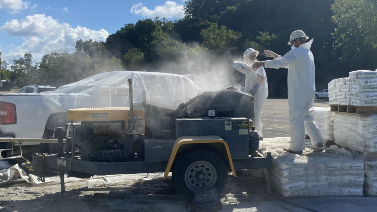 Large Diameter Sewer Rehab workers prepare pipe lining.
