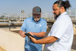 Mike Easley, chief operator at Ten Mile Creek Regional Wastewater System, reviews data with David Naranjo to determine if adjustments are needed. Mike Easley, chief operator at Ten Mile Creek Regional Wastewater System, reviews data with David Naranjo to determine if adjustments are needed.