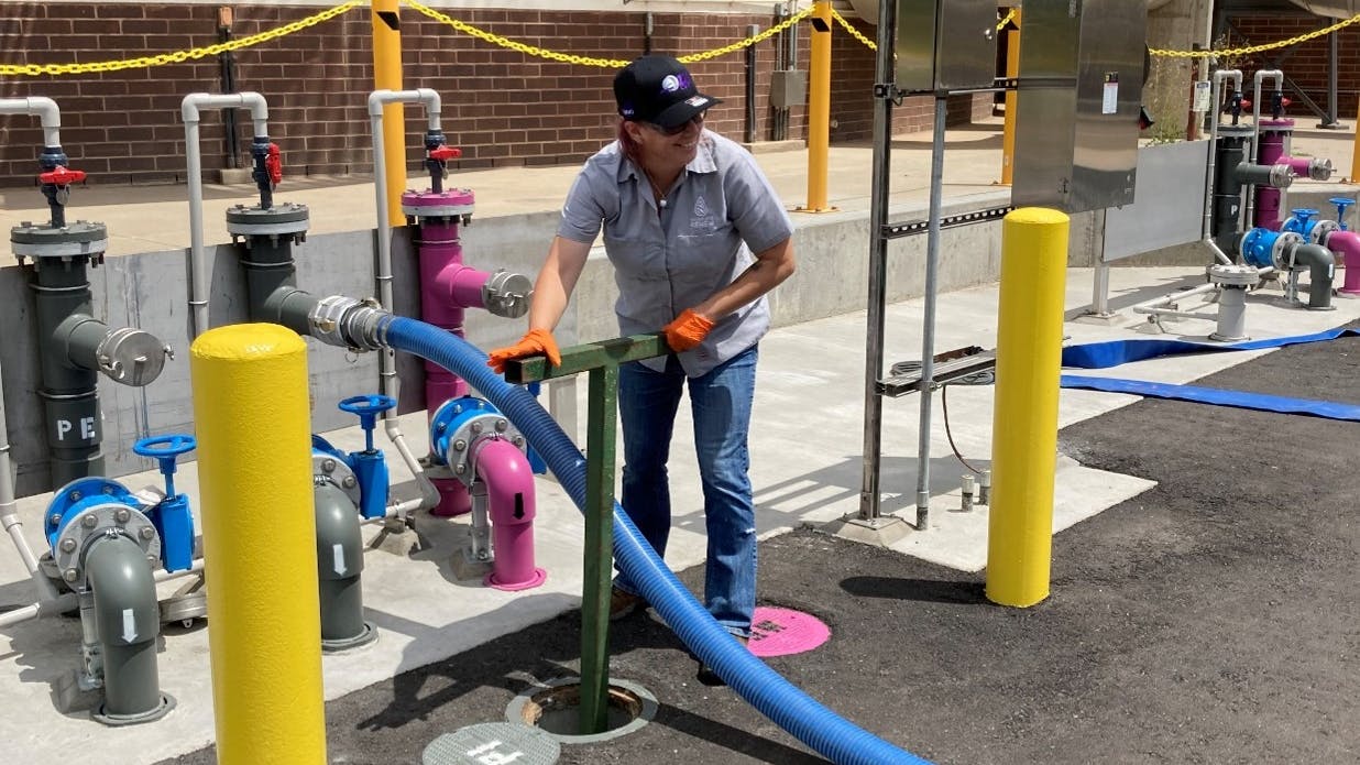 A worker turns a valve for water flow at the South Platte Renew Pilot and Research Center in Englewood, Colorado.
